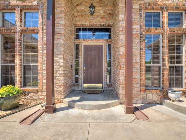 property entrance featuring stone siding