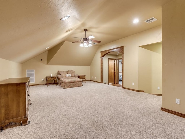 additional living space with ceiling fan, visible vents, lofted ceiling, and carpet