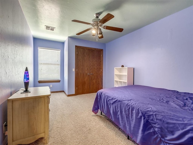 bedroom featuring baseboards, ceiling fan, light carpet, and visible vents