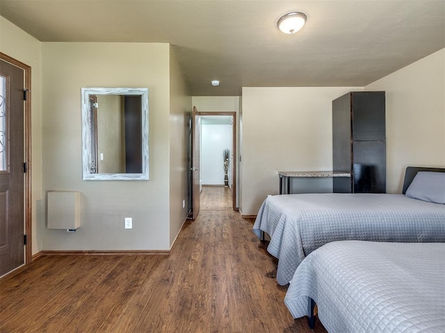 bedroom with baseboards and wood finished floors