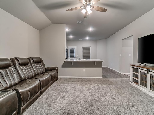 9704 Saddle Dr, Yukon, OK 73099 - living area with dark carpet, visible vents, baseboards, and a ceiling fan
