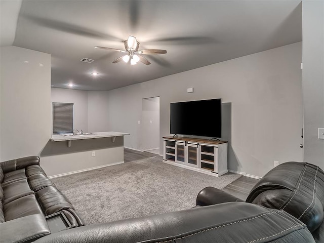 9704 Saddle Dr, Yukon, OK 73099 - carpeted living room featuring a sink, ceiling fan, baseboards, and visible vents