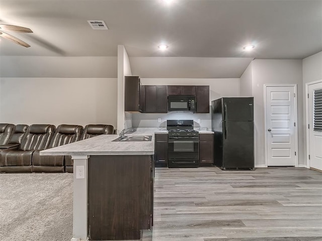 9704 Saddle Dr, Yukon, OK 73099 - kitchen with dark brown cabinetry, visible vents, black appliances, light countertops, and a sink