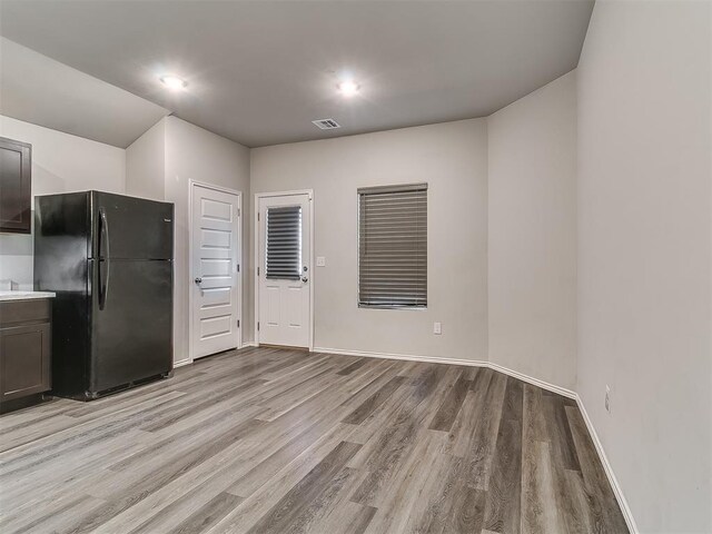 9704 Saddle Dr, Yukon, OK 73099 - kitchen featuring freestanding refrigerator, light wood-type flooring, visible vents, light countertops, and baseboards