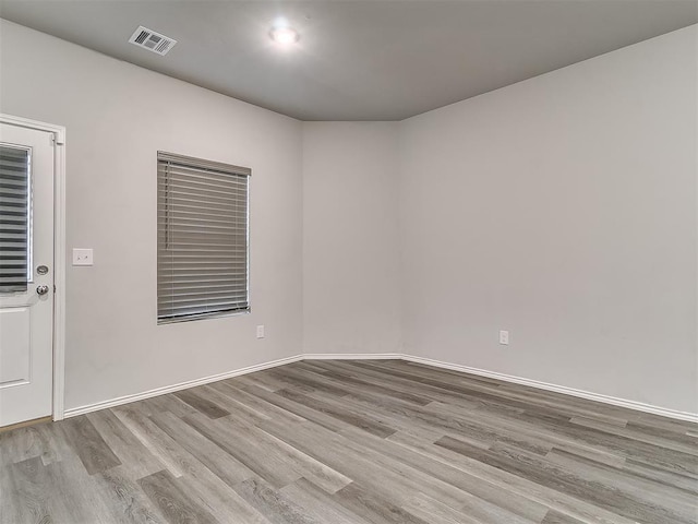 9704 Saddle Dr, Yukon, OK 73099 - unfurnished room featuring visible vents, baseboards, and wood finished floors