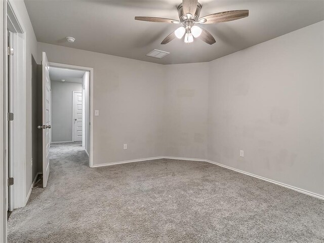 9704 Saddle Dr, Yukon, OK 73099 - carpeted empty room with ceiling fan, baseboards, and visible vents