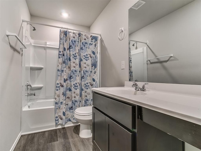 9704 Saddle Dr, Yukon, OK 73099 - full bathroom with vanity, visible vents, toilet, wood finished floors, and shower / tub combo