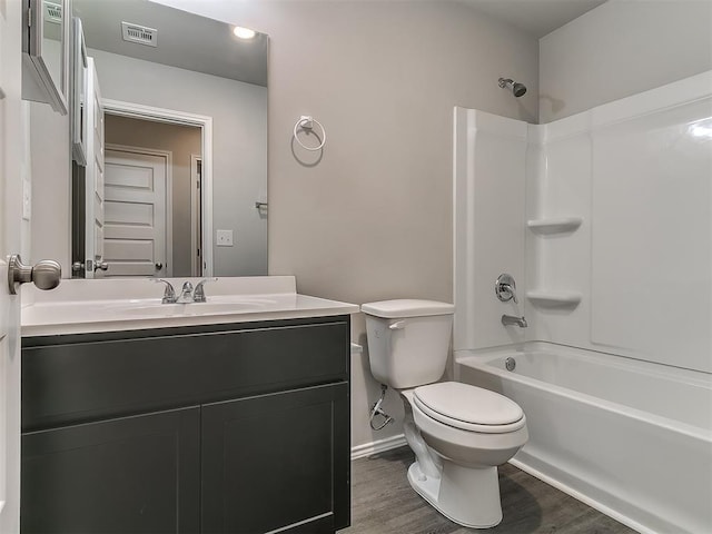 9704 Saddle Dr, Yukon, OK 73099 - full bath with visible vents, baseboards, toilet, vanity, and wood finished floors