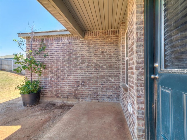 9704 Saddle Dr, Yukon, OK 73099 - entrance to property featuring a patio, fence, and brick siding