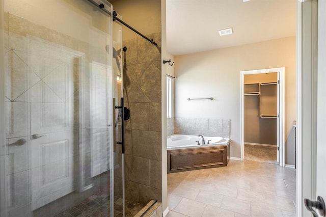 5800 SE 142nd St, Oklahoma City, OK 73165 - full bath featuring a shower stall, a bath, tile patterned flooring, and a walk in closet
