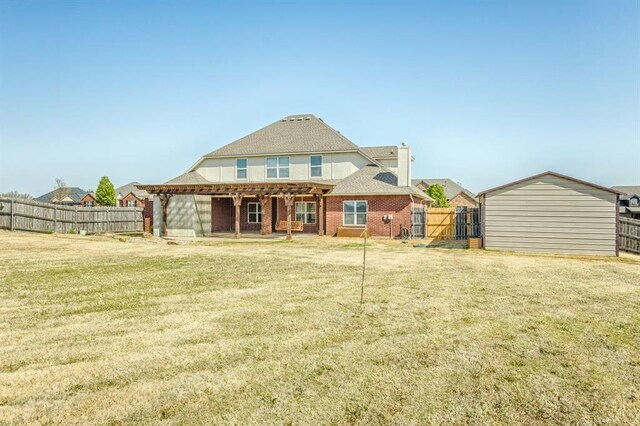 5800 SE 142nd St, Oklahoma City, OK 73165 - rear view of house featuring a pergola, a lawn, a fenced backyard, brick siding, and roof with shingles