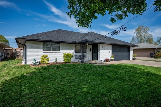 single story home with a garage, brick siding, driveway, and a front lawn
