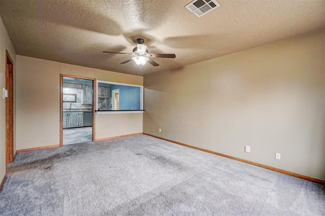 718 E Johnson St, Norman, OK 73071 - spare room with visible vents, baseboards, a ceiling fan, and carpet flooring