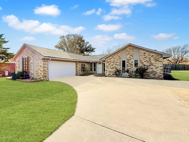 single story home featuring driveway, a garage, a front lawn, and brick siding