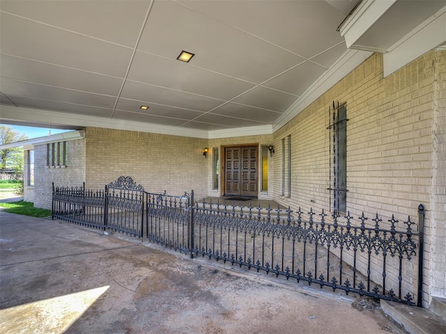 7700 S Country Club Dr, Oklahoma City, OK 73159 - doorway to property with brick siding and fence