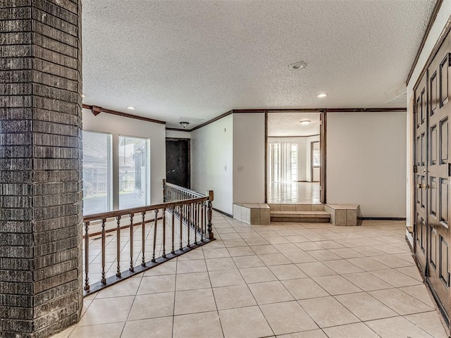 7700 S Country Club Dr, Oklahoma City, OK 73159 - unfurnished room with a textured ceiling, a wealth of natural light, crown molding, and light tile patterned floors