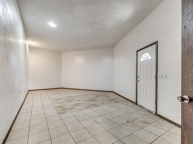 7700 S Country Club Dr, Oklahoma City, OK 73159 - foyer with baseboards, light tile patterned flooring, and a textured ceiling