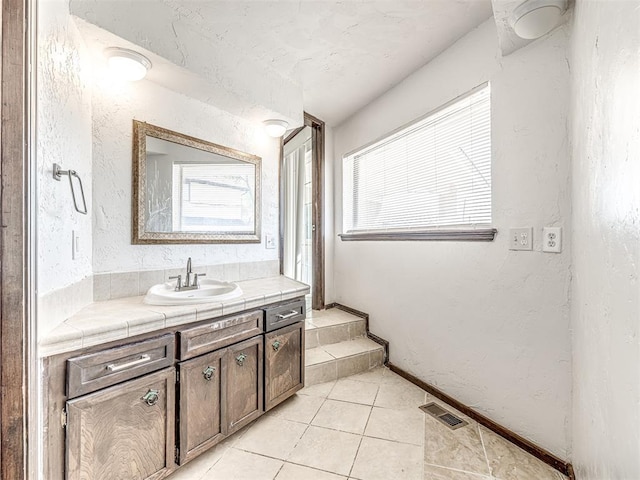 7700 S Country Club Dr, Oklahoma City, OK 73159 - bathroom with a textured wall, visible vents, tile patterned flooring, and vanity