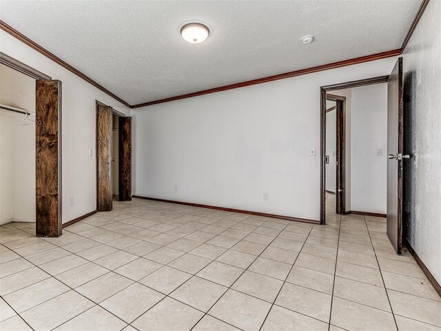 7700 S Country Club Dr, Oklahoma City, OK 73159 - unfurnished bedroom featuring baseboards, crown molding, and a textured ceiling