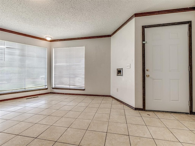 7700 S Country Club Dr, Oklahoma City, OK 73159 - spare room featuring visible vents, a textured ceiling, light tile patterned floors, and crown molding