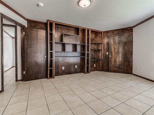 7700 S Country Club Dr, Oklahoma City, OK 73159 - interior space featuring a textured ceiling, wood walls, ornamental molding, and light tile patterned floors