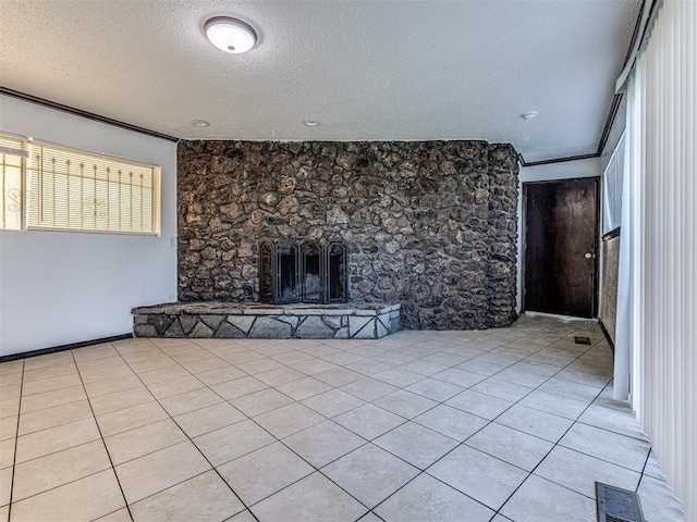 7700 S Country Club Dr, Oklahoma City, OK 73159 - unfurnished living room with a stone fireplace, a textured ceiling, light tile patterned floors, ornamental molding, and visible vents