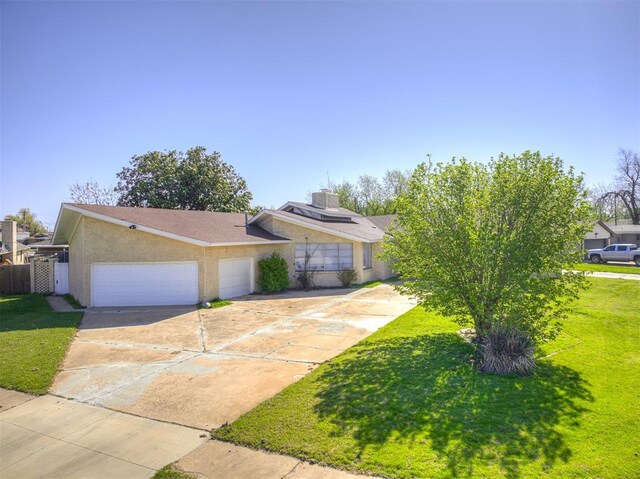 7700 S Country Club Dr, Oklahoma City, OK 73159 - view of front of home with concrete driveway, an attached garage, stucco siding, and a front yard