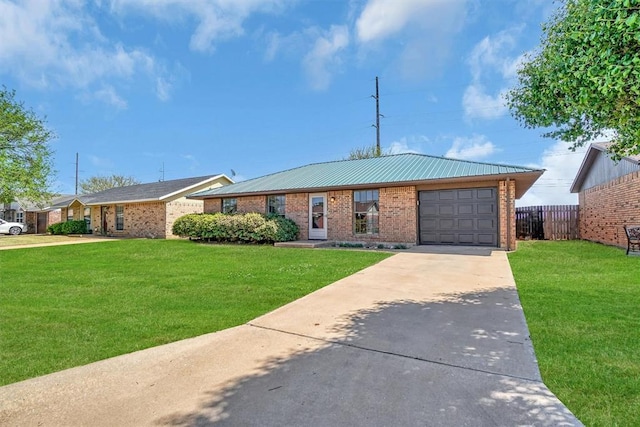single story home featuring driveway, a front yard, brick siding, a garage, and metal roof