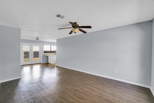 unfurnished living room featuring baseboards, a textured ceiling, a ceiling fan, and dark wood finished floors