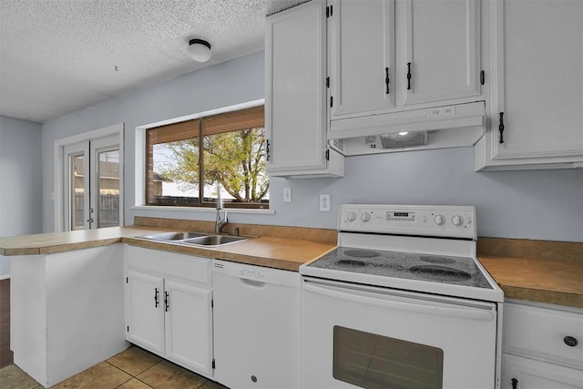 kitchen featuring white appliances, a textured ceiling, white cabinets, under cabinet range hood, and a sink