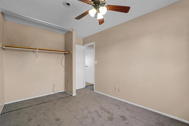 unfurnished bedroom featuring carpet, a textured ceiling, baseboards, and a ceiling fan