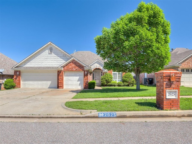 view of front of property featuring an attached garage, a front lawn, brick siding, and concrete driveway