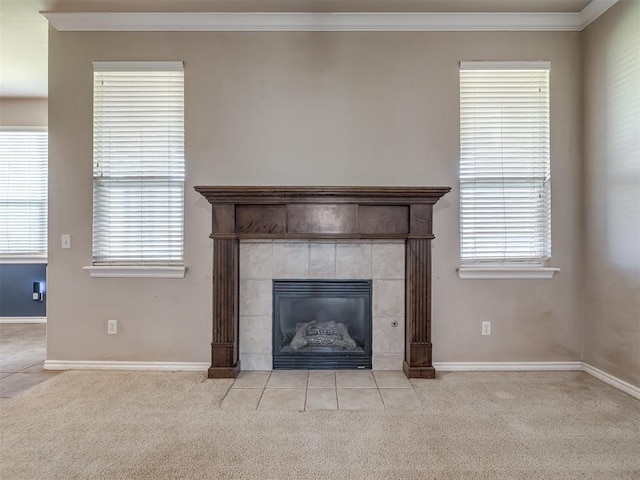interior details featuring carpet floors, crown molding, baseboards, and a fireplace