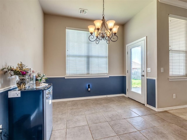 unfurnished dining area featuring light tile patterned floors, a wealth of natural light, and a notable chandelier