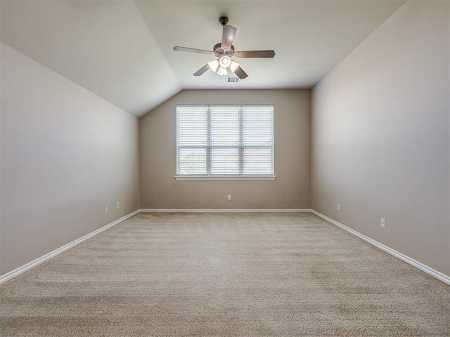 additional living space featuring baseboards, ceiling fan, lofted ceiling, and light colored carpet