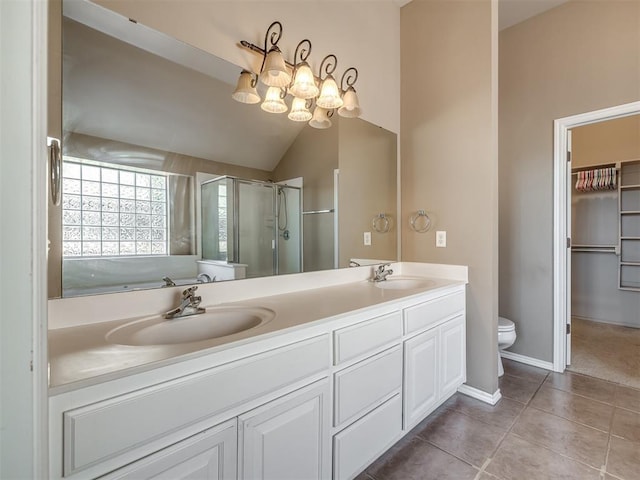 full bath featuring a sink, a stall shower, toilet, and tile patterned floors