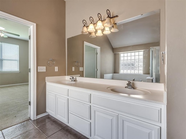 full bathroom with double vanity, a wealth of natural light, and a sink