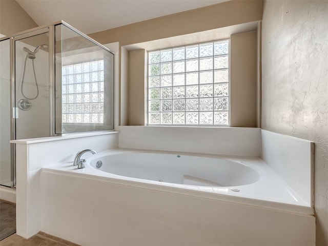 bathroom featuring a bath and a stall shower
