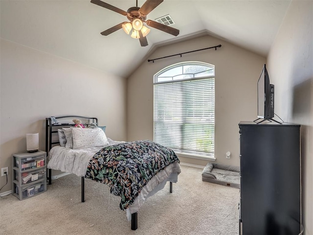 carpeted bedroom featuring ceiling fan, vaulted ceiling, and visible vents