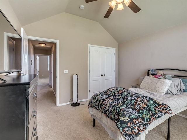 bedroom with a ceiling fan, baseboards, vaulted ceiling, and light carpet