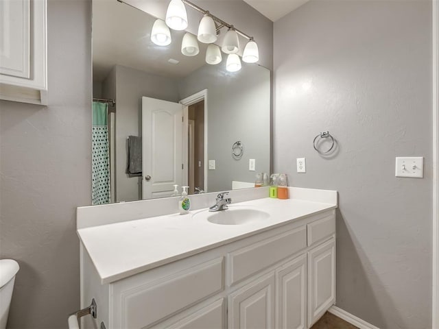 bathroom featuring vanity and toilet