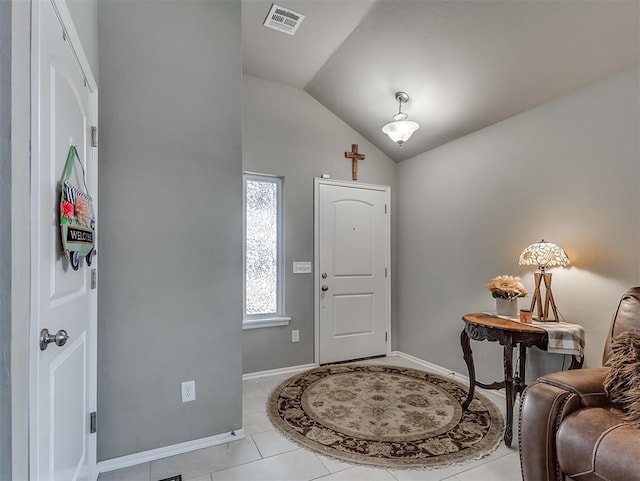 entrance foyer featuring lofted ceiling, light tile patterned floors, visible vents, and baseboards