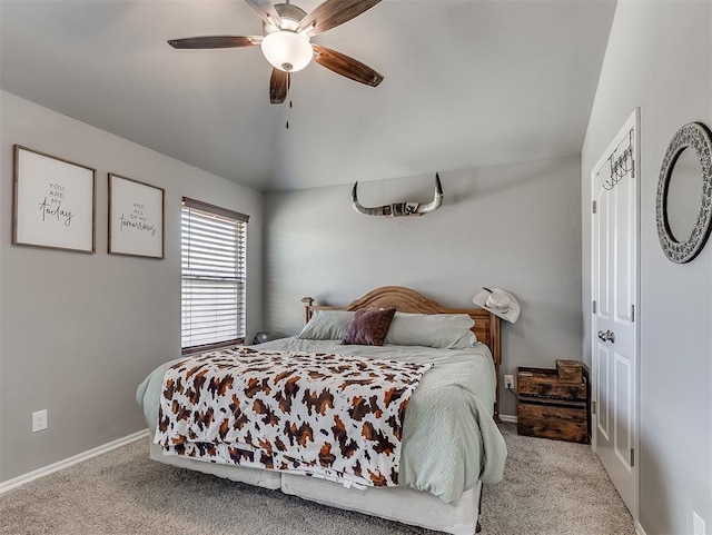 bedroom featuring baseboards, ceiling fan, carpet flooring, and vaulted ceiling