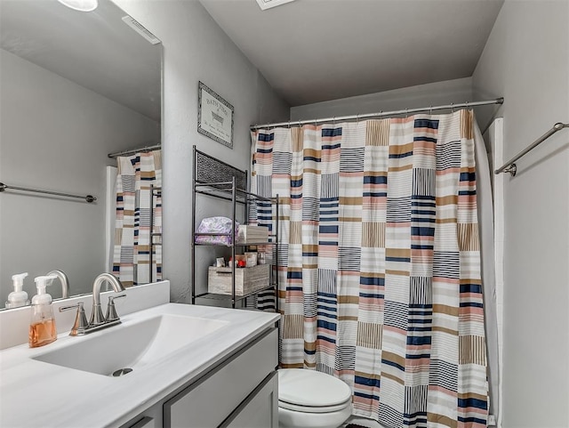 bathroom featuring toilet, vanity, and a shower with shower curtain