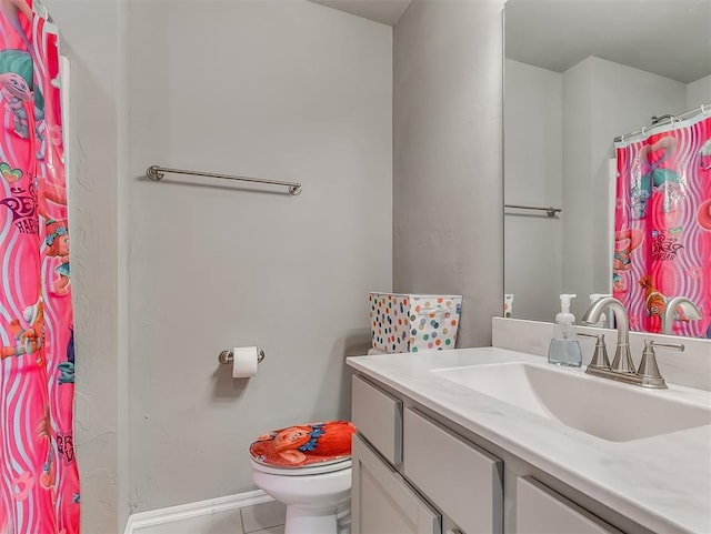 bathroom featuring a shower with curtain, vanity, tile patterned floors, toilet, and baseboards