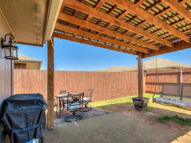 view of patio with grilling area, outdoor dining area, and a fenced backyard