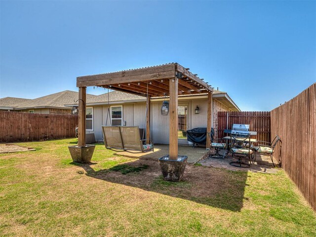 back of house with a patio, a yard, and a fenced backyard
