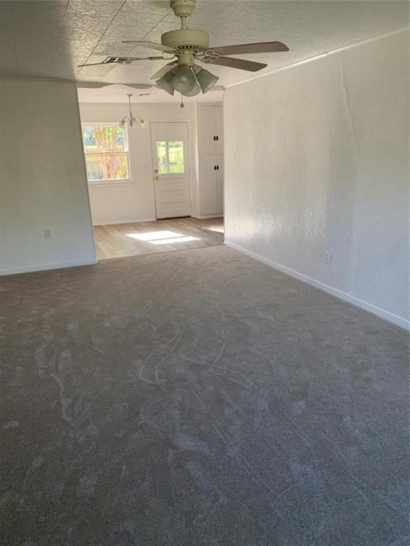 1006 N Market St, Shawnee, OK 74801 - unfurnished room featuring carpet flooring, baseboards, and a ceiling fan