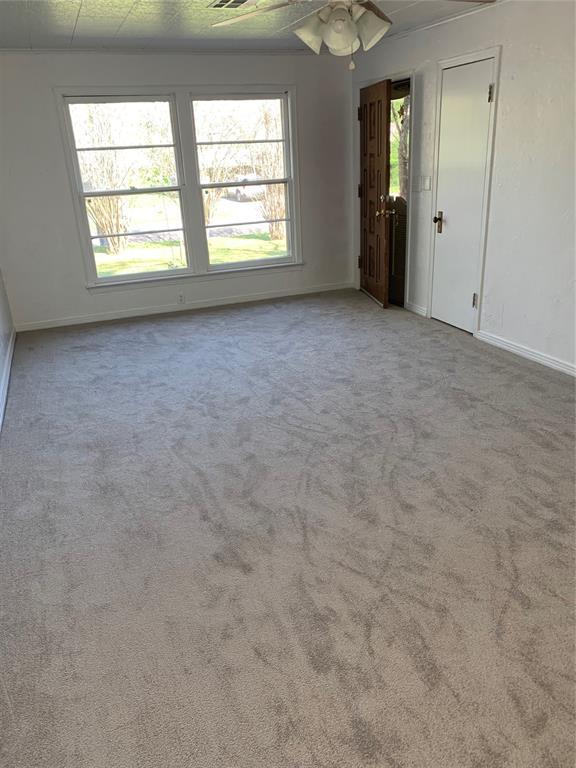 1006 N Market St, Shawnee, OK 74801 - empty room with baseboards, a ceiling fan, and carpet floors