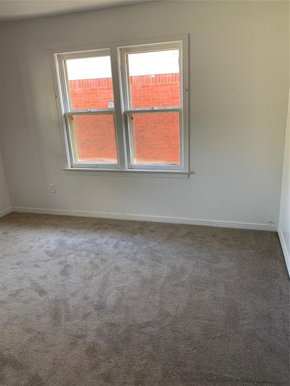 1006 N Market St, Shawnee, OK 74801 - empty room with baseboards and carpet floors